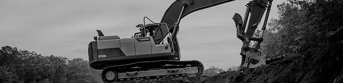 orange and white excavator on brown grou