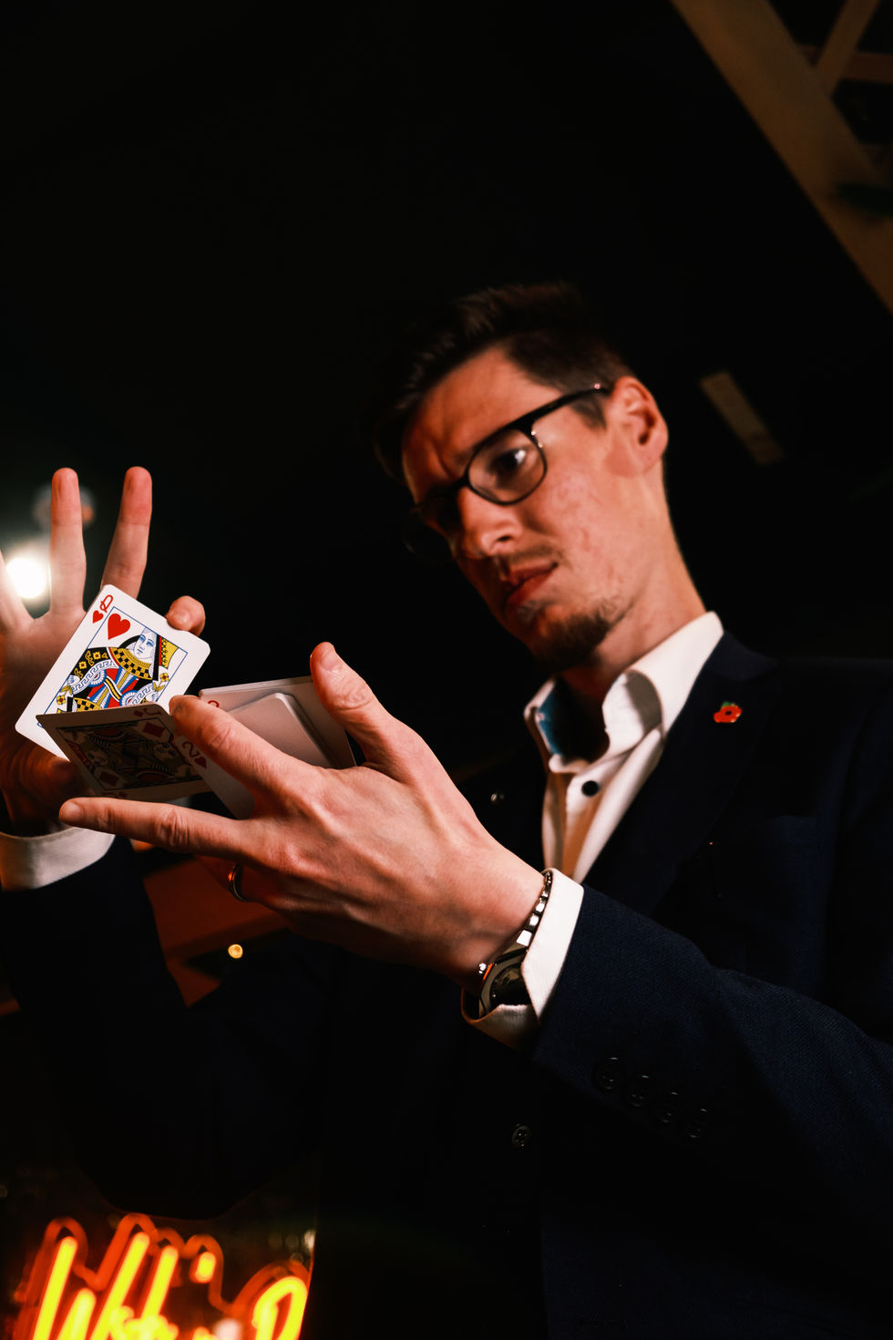 Portrait of Jamie Warren performing magic at a private show in Doncaster. The Queen of Hearts Card is revealed.