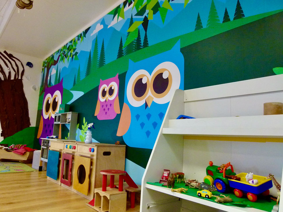 Wall fully covered with graphics of a fun landscape and cartoon owls