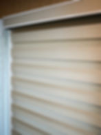 Light-colored horizontal window treatment blinds