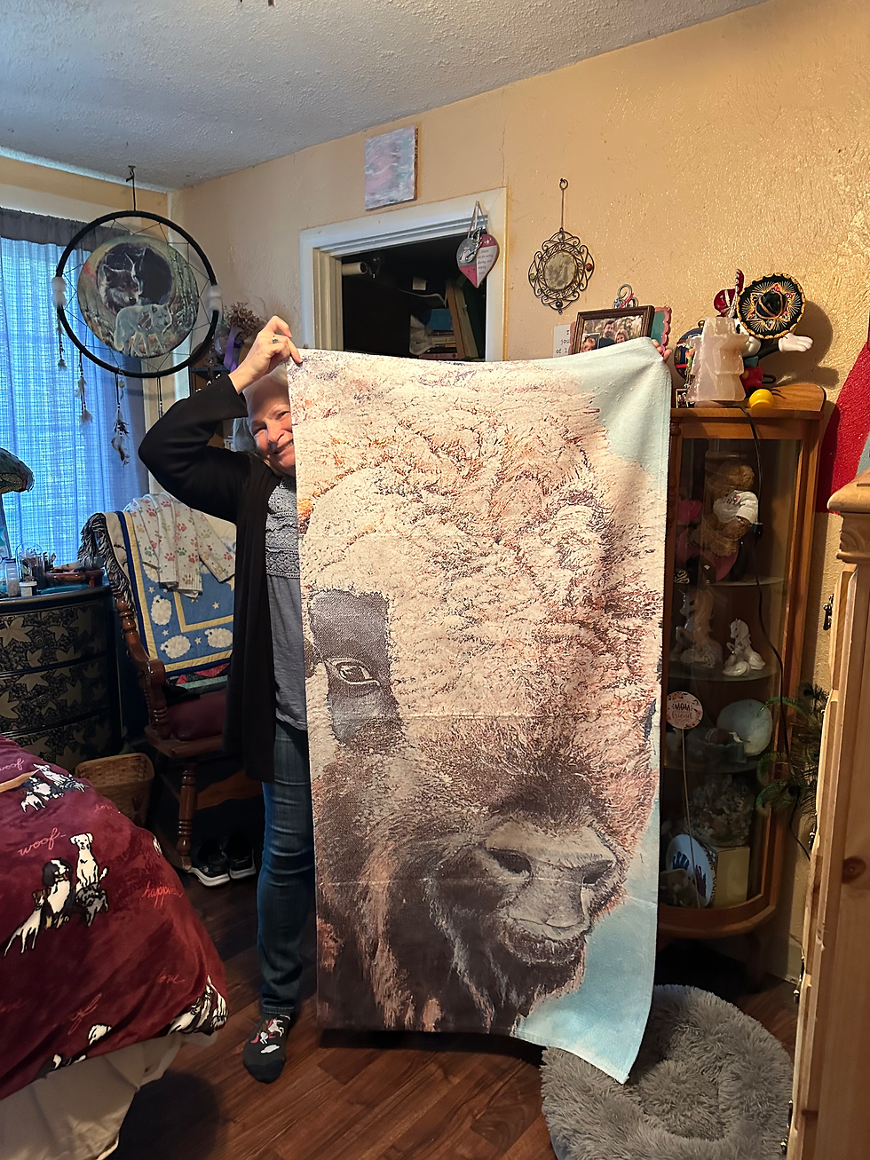 Customer holding my artwork on a beach towel
