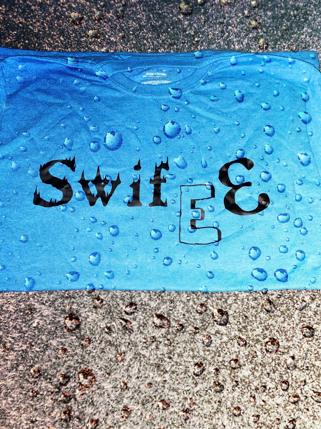 Baby blue shirt black letters (Swifee logo )