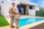 proud-couple-contemplating-their-newly-bought-home-2024-12-10-00-28-12-utc.jpg