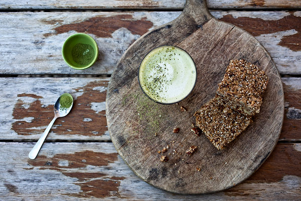 Latte drink and flapjack served on rustic dinner wear