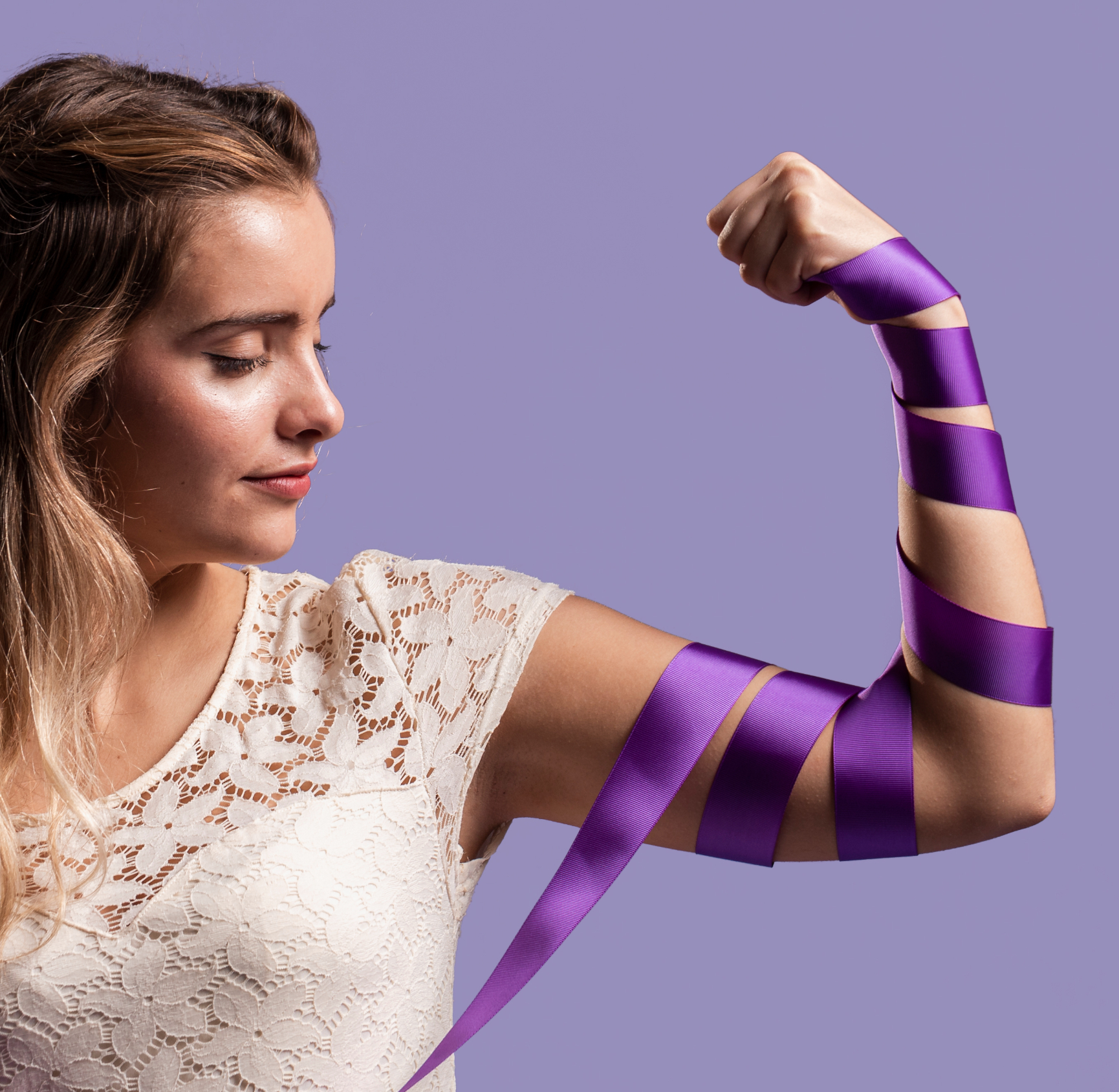 woman-flexing-her-arm-with-ribbon-copy-space_edited.jpg