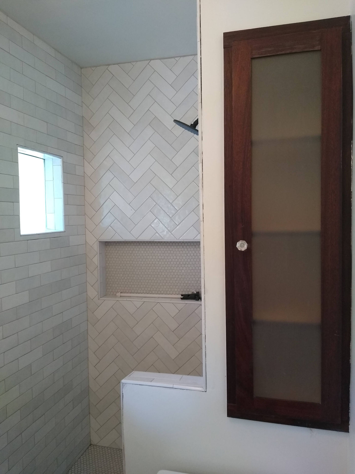 Retiled shower with niche and window