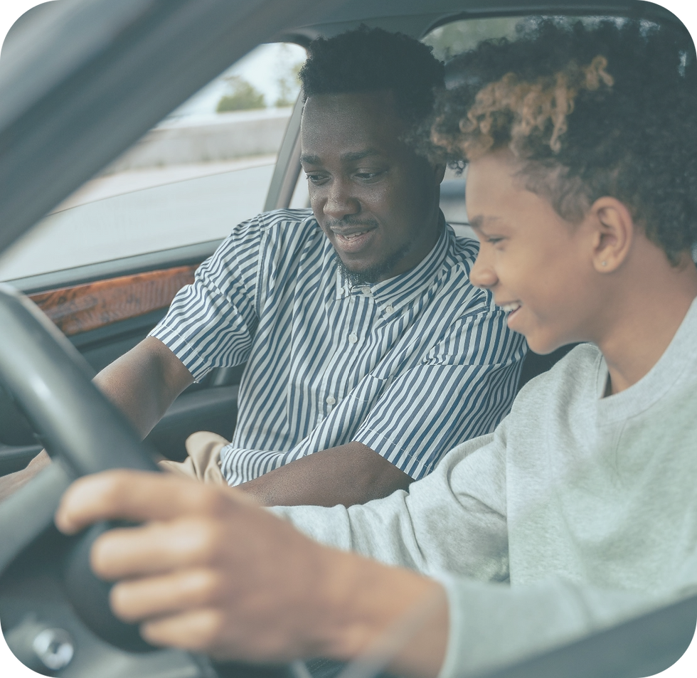 Father teaching son how to drive, an important milestone that may require teen or family therapy to help achieve