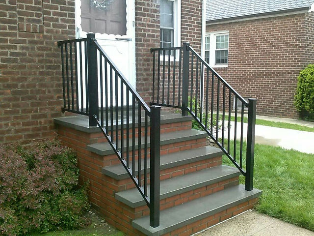 Black metal railing on steps of a house, North Shore Fence Co