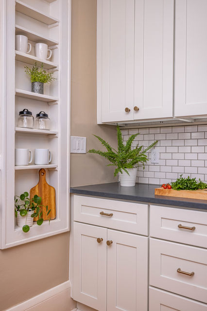 White kitchen with subway tile backsplash, shaker cabinets, and dark countertops