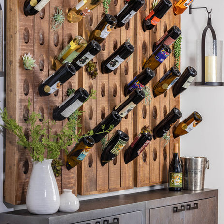 Buffet cabinet with hanging wine storage, white vases, and greenery
