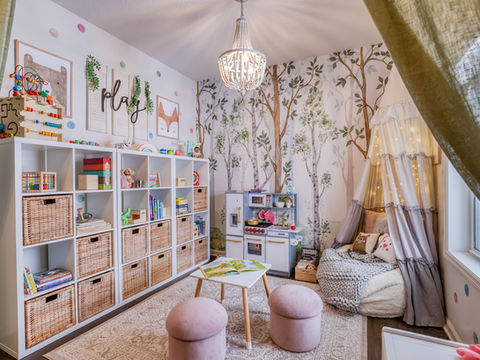 Playroom with built in storage, woven baskets, forest wallpaper, and cozy seating nook