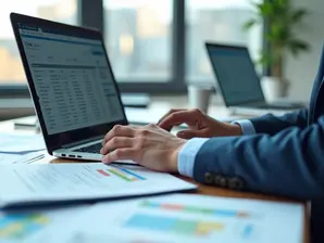 Pessoa analisando tabelas e classificações CNAE em notebook com documentos de contabilidade ao redor