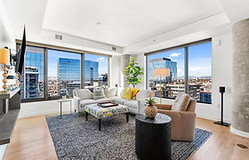 Bright living room with large windows and city views