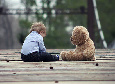 Baby boy playing with Teddy Bear