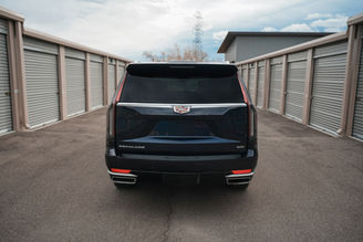 Rear view of blue Cadillac Escalade rental