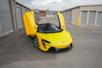 Front view of yellow McLaren Artura rental