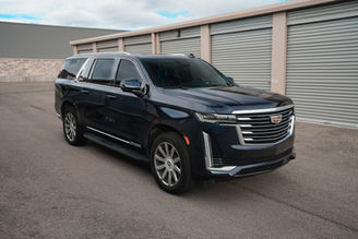 Side view of blue Cadillac Escalade rental