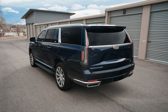 Rear view of blue Cadillac Escalade rental