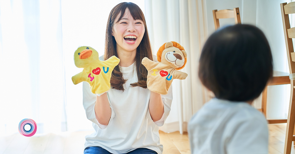 Preparing your child for school - picture shows adult, with hand puppets, smiling. A child is watching.