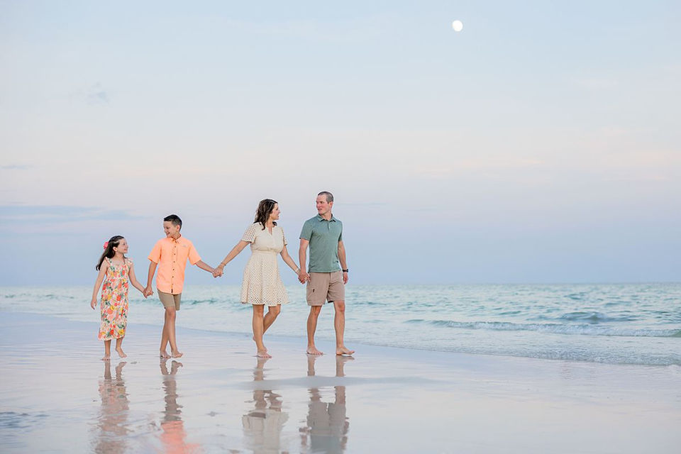 family walking down the beach at sunset in 30a