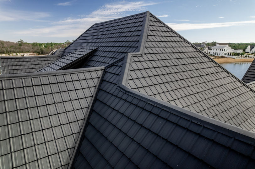 A large white house with a luxury slate roof and design