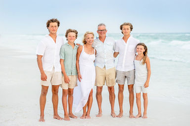 family standing on the beach in 30a photography by seagrove studios photographer