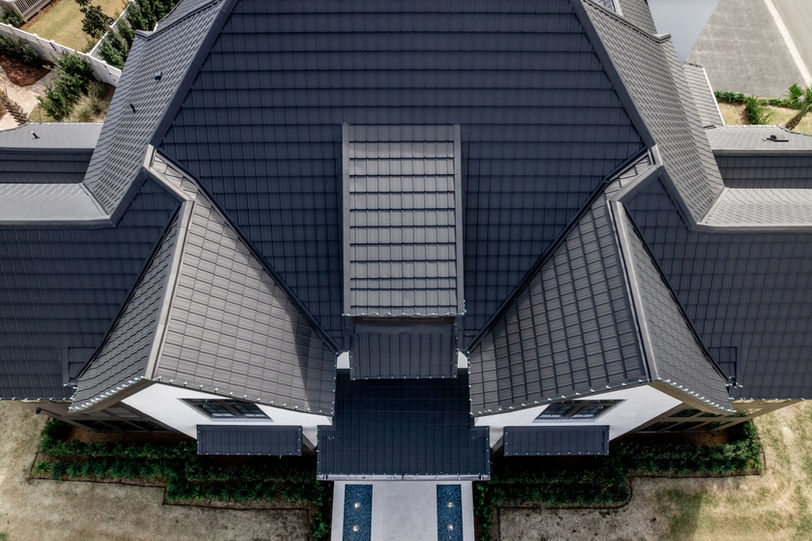 A large white house with a luxury slate roof and design