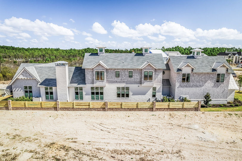 A large white house with a luxury shingle roof and design