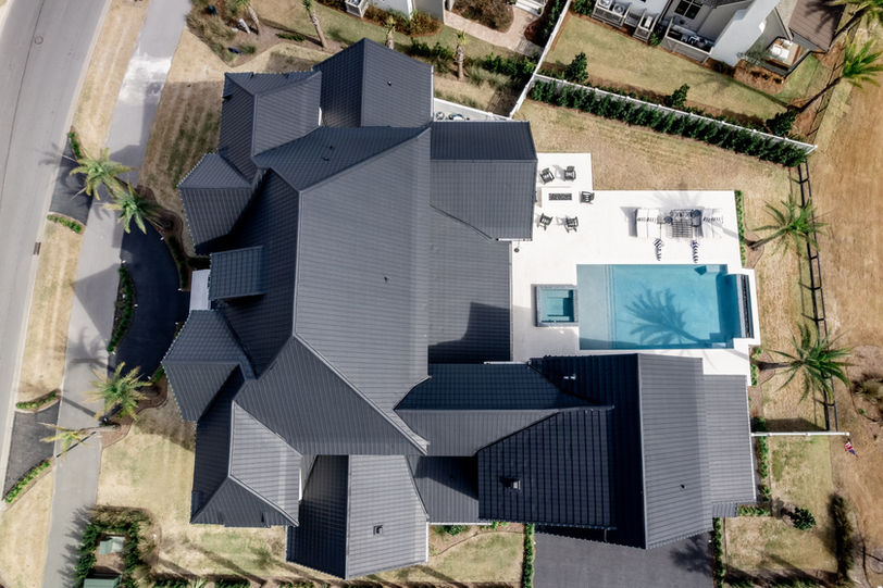 A large white house with a luxury slate roof and design