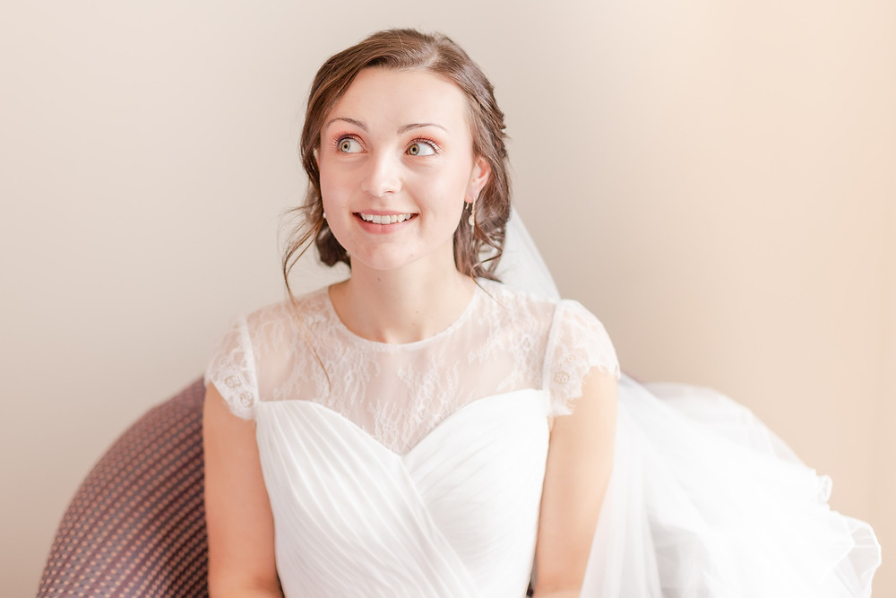 bride looking up and smiling after getting ready for her wedding