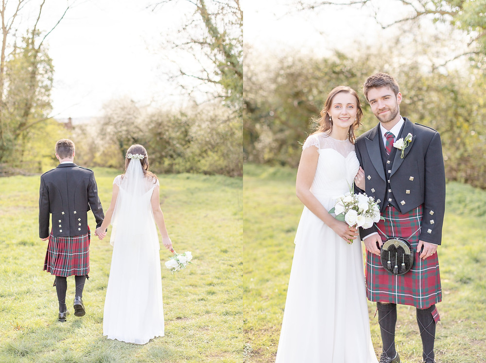 Bride and groom walk through a sunny field and smile for their portrait session.