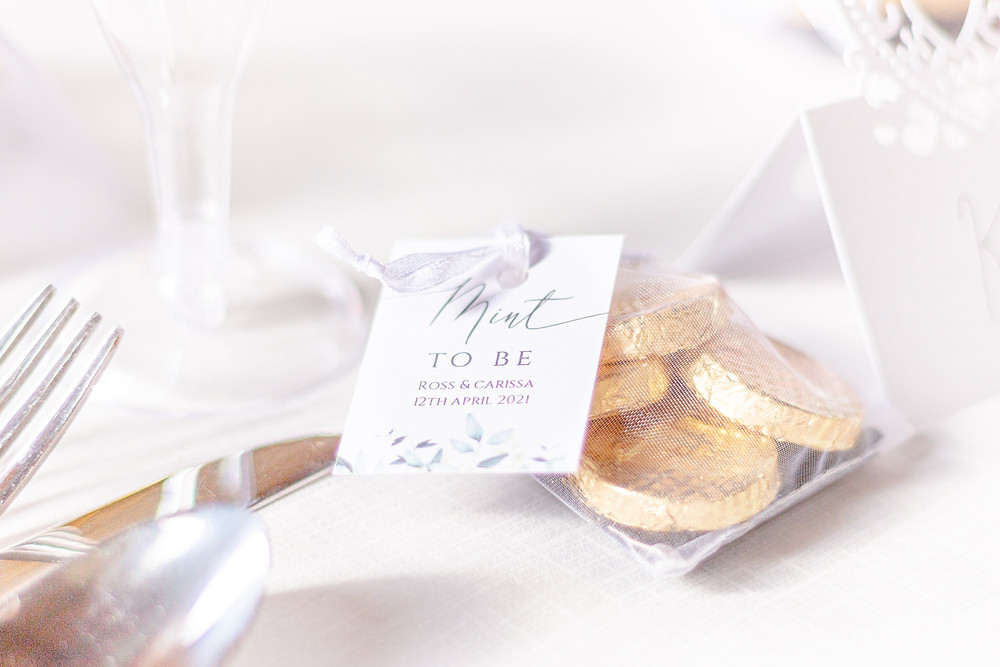 Detail photo of a wedding favour bag filled with chocolate mints and a tag that says "Mint to be"
