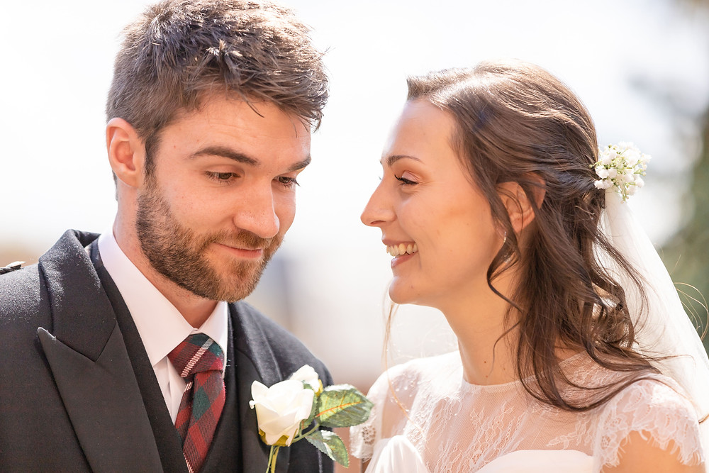 bride and groom share a laugh after coming out of the wedding ceremony