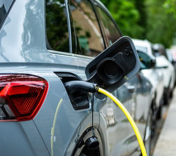 An electric car plugged in on charge on a residential street in central London.jpg