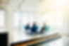 Business leaders meeting in a bright glass conference room to discuss strategy and organizational execution.