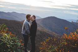 Two grooms kissing during their elopement at Craggy Gardens, NC