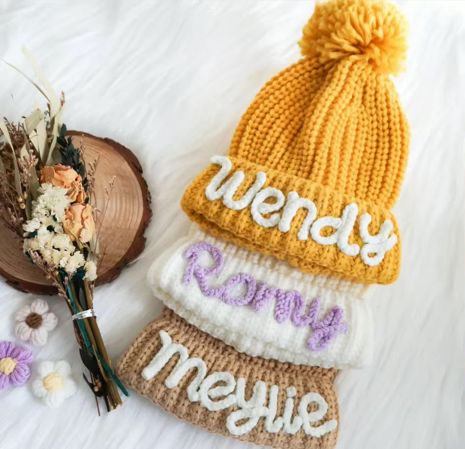 <img src="personalized-knit-hat.jpg" alt="Personalized knit hat with name embroidery in beige, mustard, and white colors">