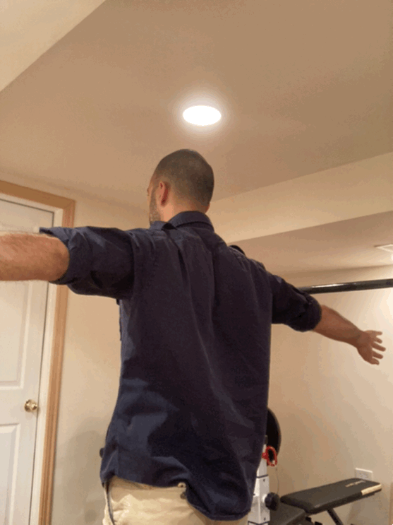 Reaching behind the back to challenge internal rotation motion and strength.