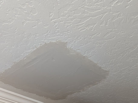 Ceiling drywall repair in progress with bracing and first coat applied, prior to final skip trowel texture in Salem, UT.