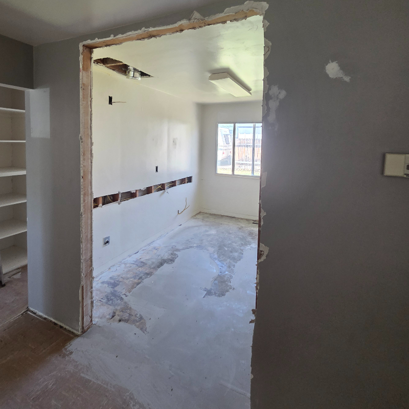 Exposed wall openings and lath following utility installations, showing the site conditions before professional plaster restoration.