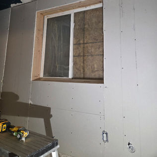 Damaged basement wall & ceiling in progress prior to drywall finish & trim installation.