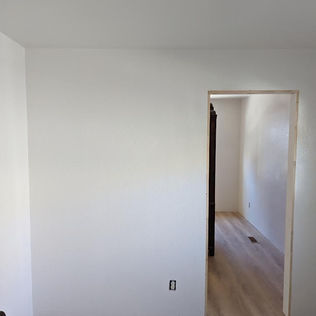 A completed drywall divider with professional texture, ready for final painting.