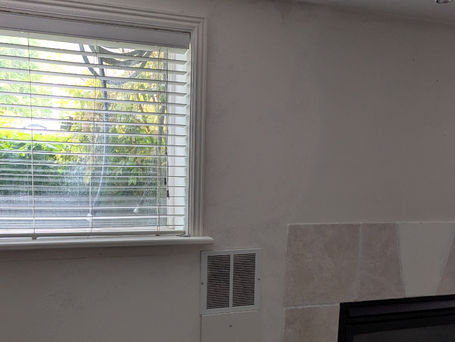 After photo of a completed drywall repair around a window with a light knockdown texture finish in Orem, Utah.