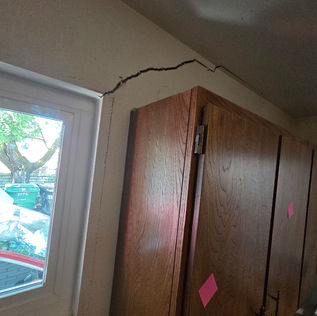 Drywall settling cracks from window to ceiling and along the wall in Provo, Utah
