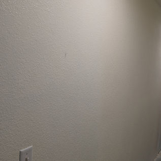 Smooth, light-colored hallway wall renovation, closing off hallway access.