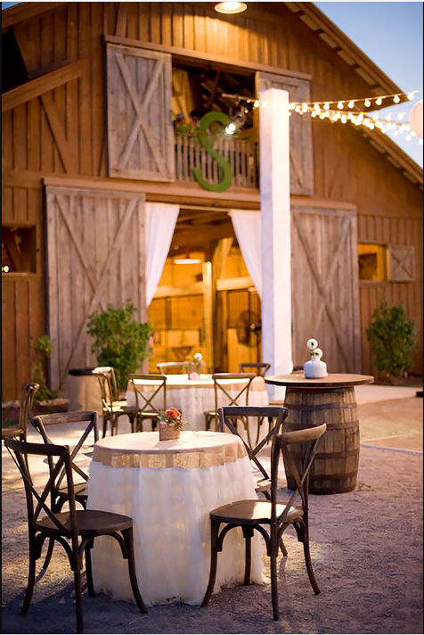 Eye-level view of rustic barn interior with wooden beams and natural light