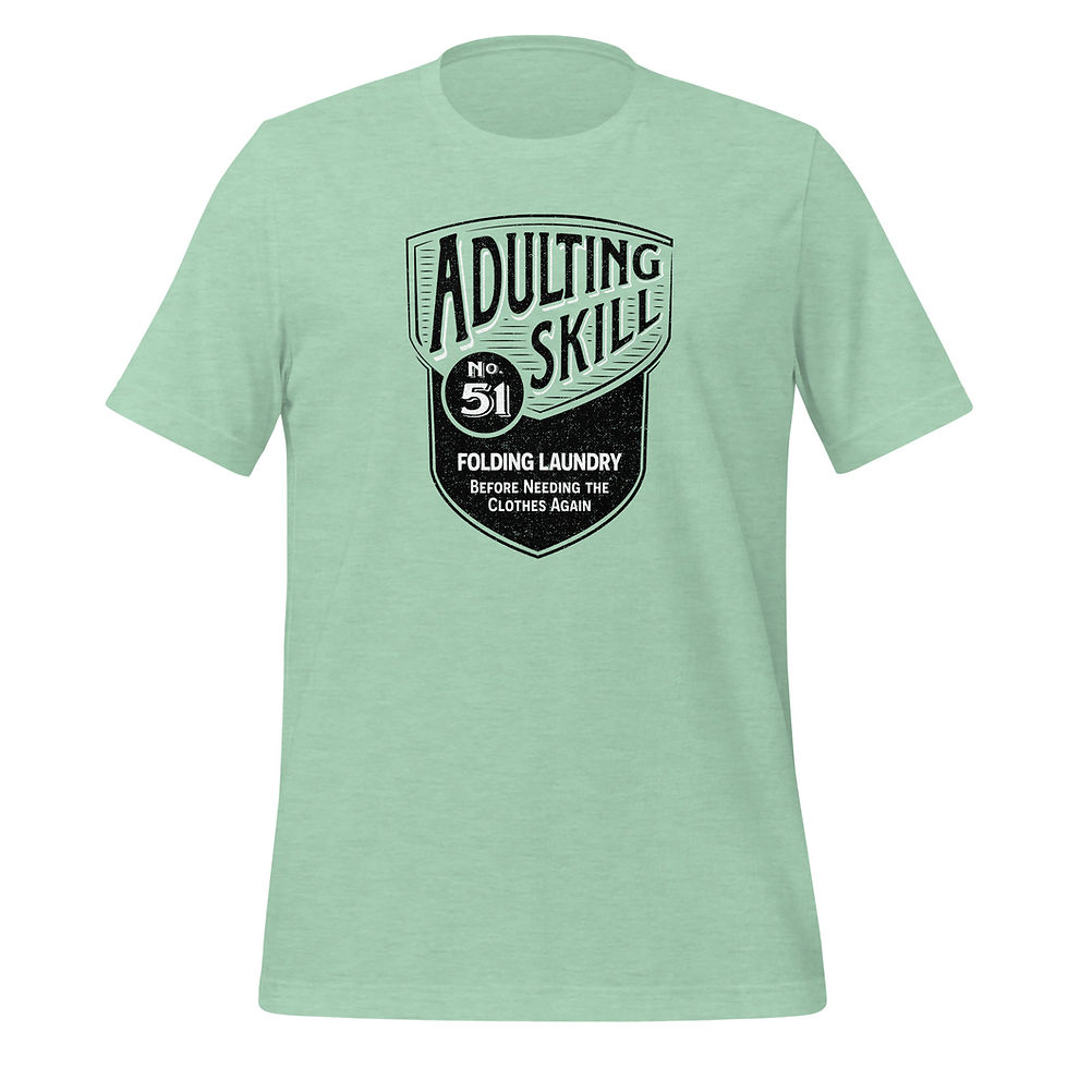 Thumbnail: Mint t-shirt with a black shield design that reads Adulting Skill 51, Folding Laundry Before Needing The Clothes Again.