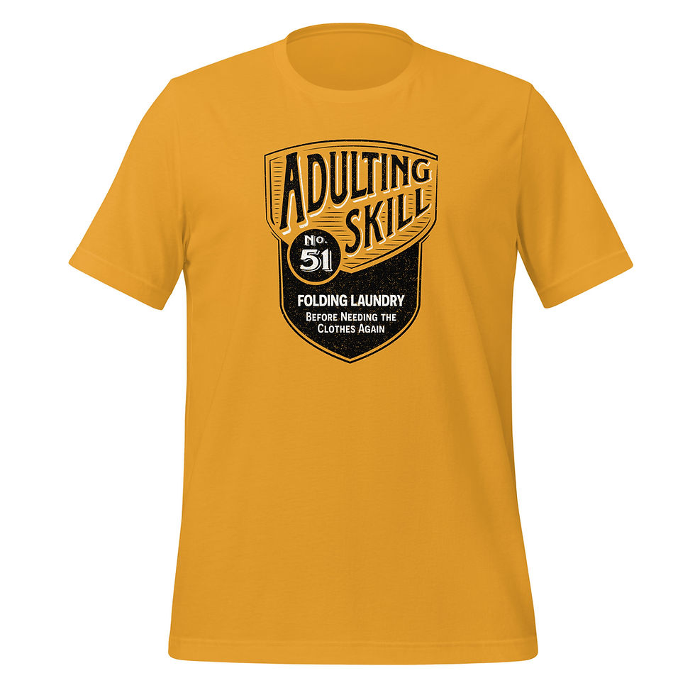 Thumbnail: Mustard t-shirt with a black shield design that reads Adulting Skill 51, Folding Laundry Before Needing The Clothes Again.
