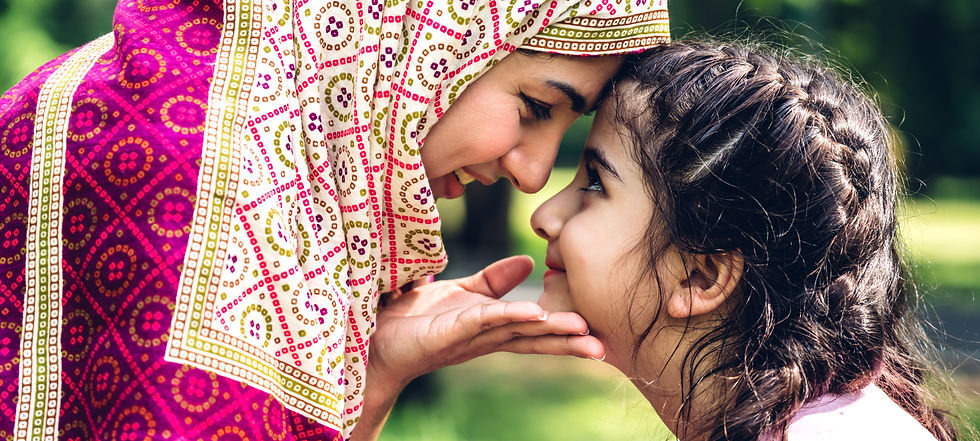 Muslim woman smiling to daughter