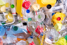 Assorted plastic bottles, containers, and bags for recycling